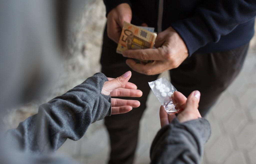 What is the difference between drug trafficking and drug dealing