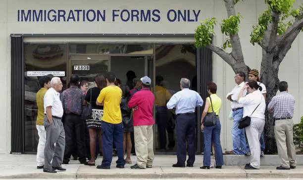 A line forms near the entrance of the immigration and naturalization service office in miami
